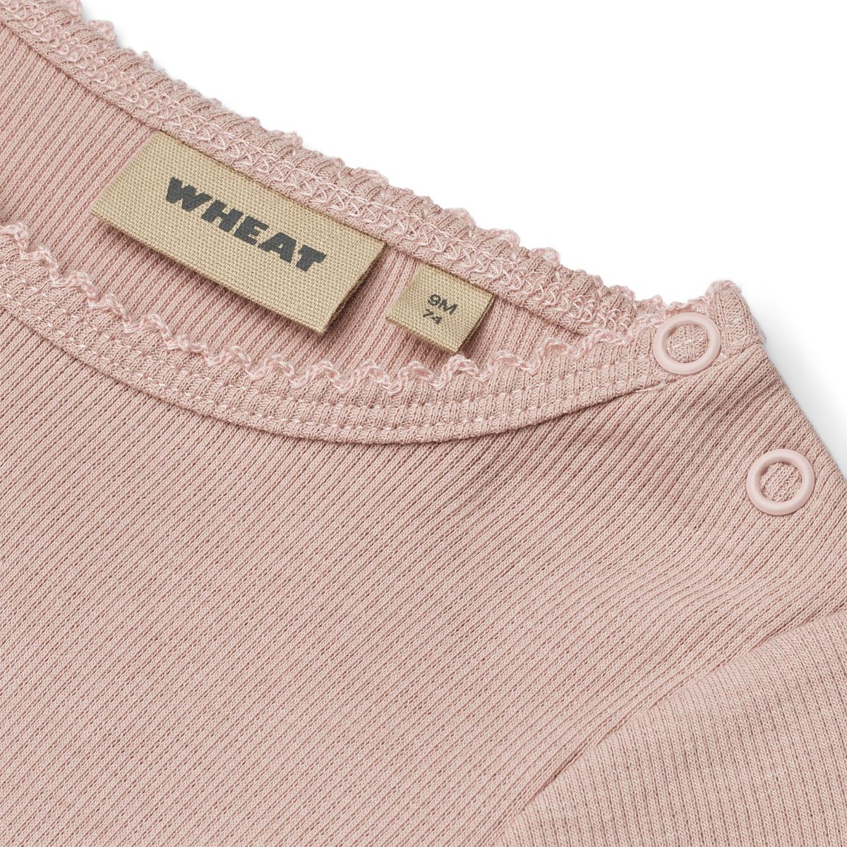 Close up product image of a long sleeve baby bodysuit